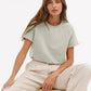 Woman in mint green t-shirt and beige wide-leg pants, casual fashion outfit