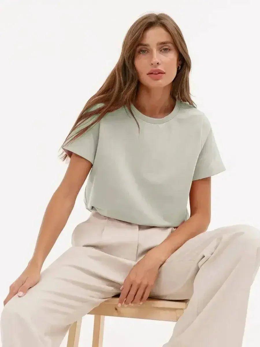 Woman in mint green t-shirt and beige wide-leg pants, casual fashion outfit