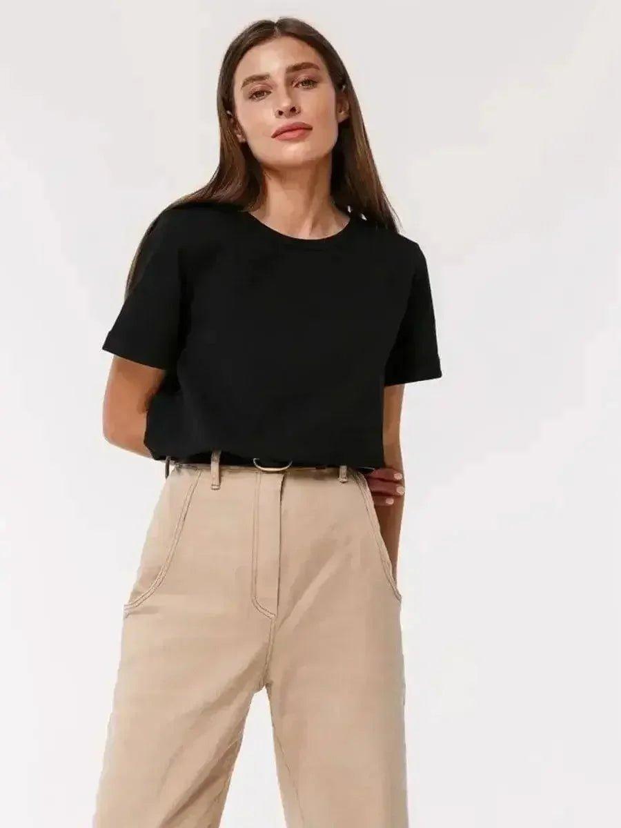 Woman in black crop top and beige high-waist pants, stylish casual fashion outfit