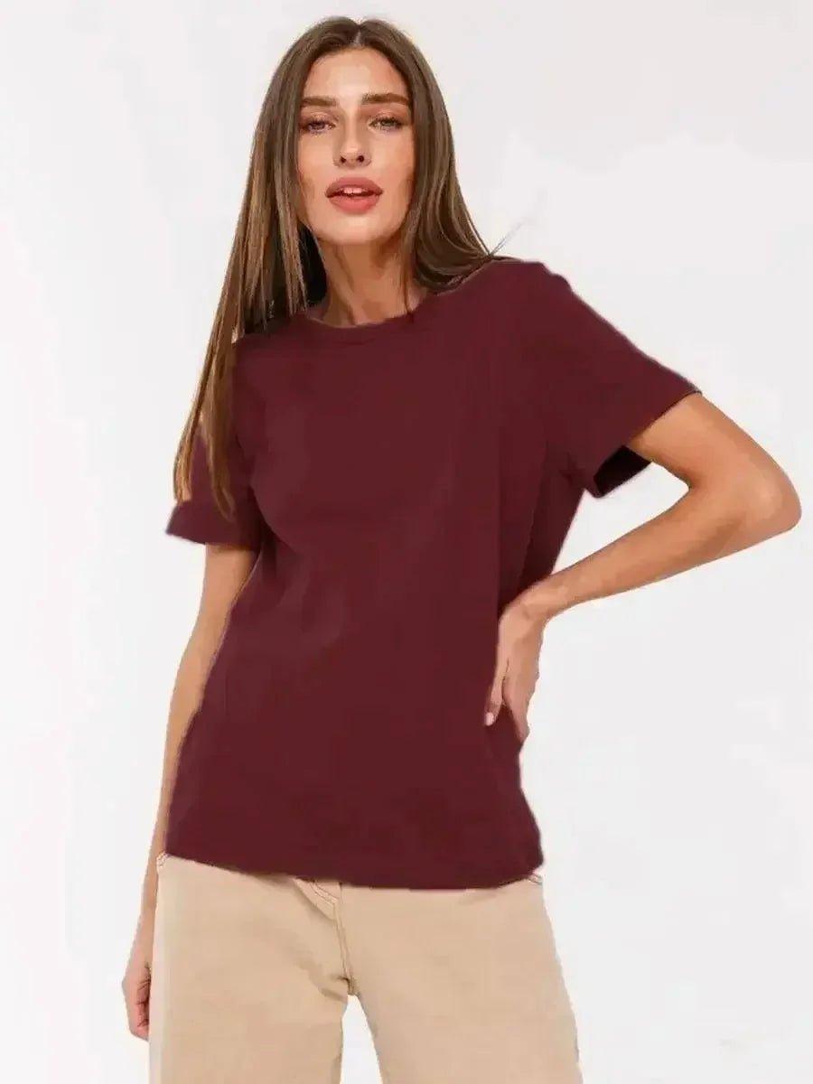 Woman wearing burgundy t-shirt and beige pants, stylish casual fashion