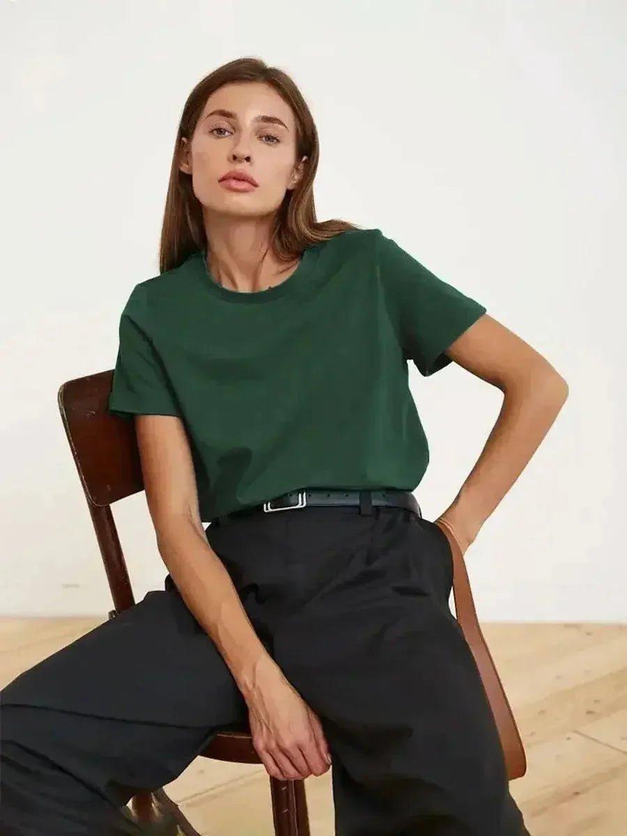 Woman modeling green t-shirt and black pants, stylish casual fashion outfit