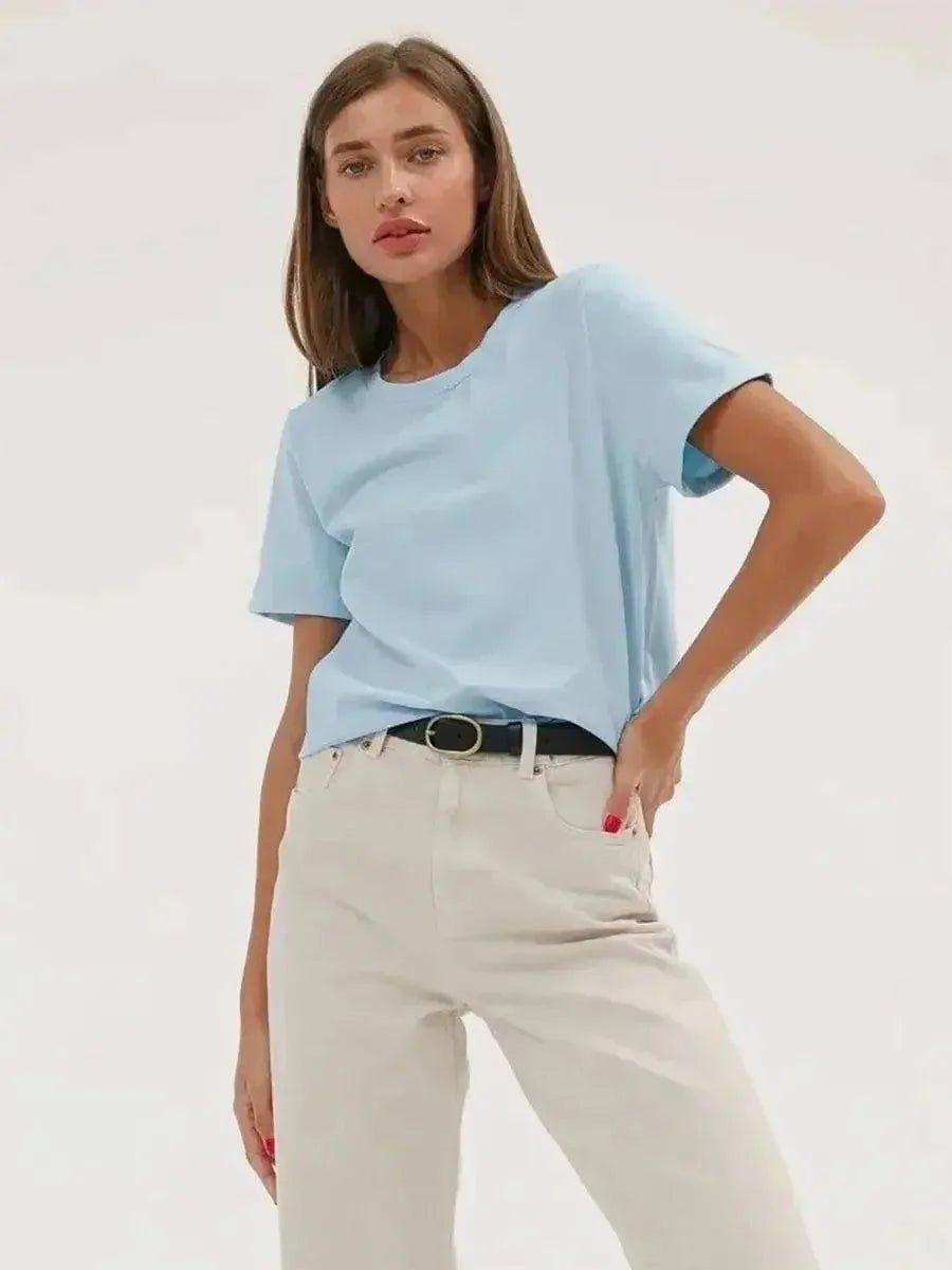 Woman in light blue t-shirt and white pants, casual fashion outfit