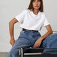 Woman in white t-shirt and high-waisted jeans, casual fashion outfit