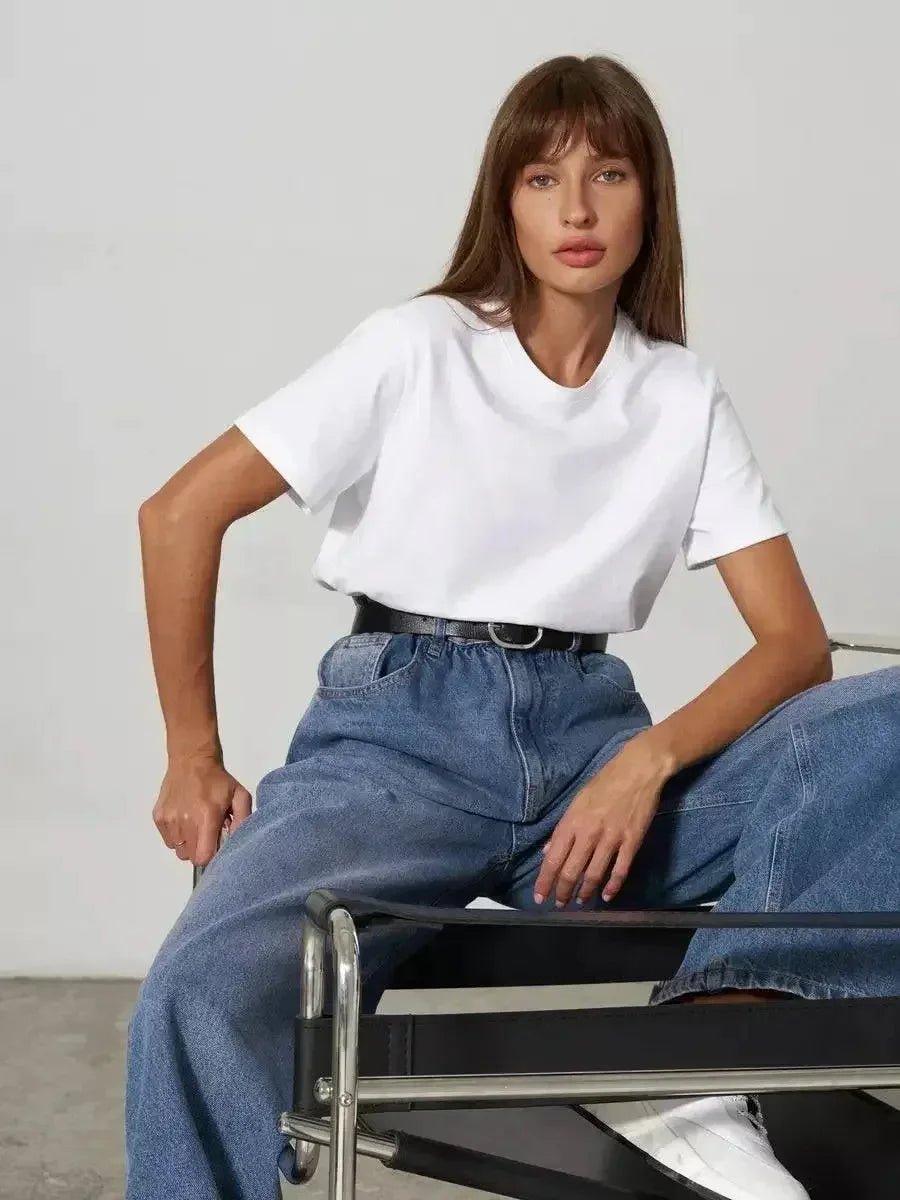 Woman in white t-shirt and high-waisted jeans, casual fashion outfit