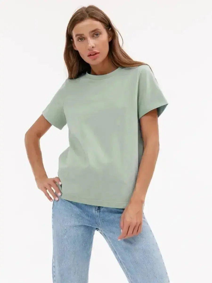 Woman wearing mint green oversized t-shirt with blue jeans, casual fashion outfit