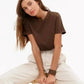 Woman in brown t-shirt and white pants, casual fashion style