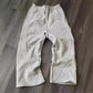 Gray women's sweatpants with side stripes, casual lounge wear on wood floor