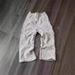 Gray women's jogger pants with side stripes, laid on wood floor