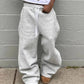Gray wide-leg sweatpants with side stripes, drawstring waist, paired with cozy slippers for casual fashion