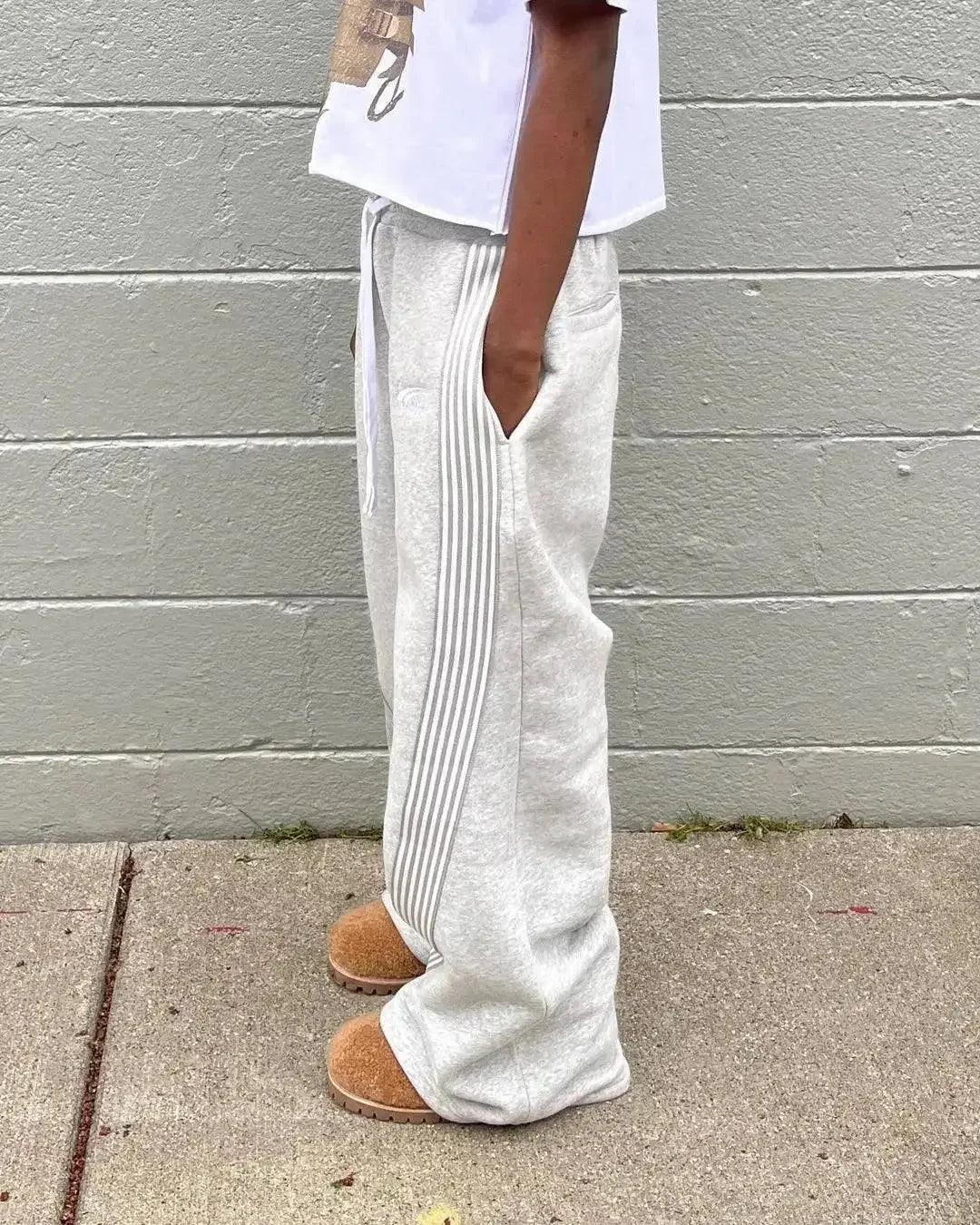 Gray wide-leg sweatpants with side stripes, casual streetwear style