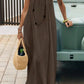 Woman in olive maxi dress with straw bag, boho summer fashion outfit