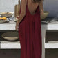 Woman in red backless maxi dress, summer fashion, beach style, boho chic, outdoor dining