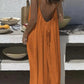 Woman in orange backless maxi dress, summer fashion, beach style, casual elegance