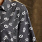 Woman wearing dark gray short sleeve shirt with skull, cereal bowl, and milk carton print, fashion style