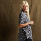 Woman in edgy skull print shirt, fashion-forward style for women's streetwear