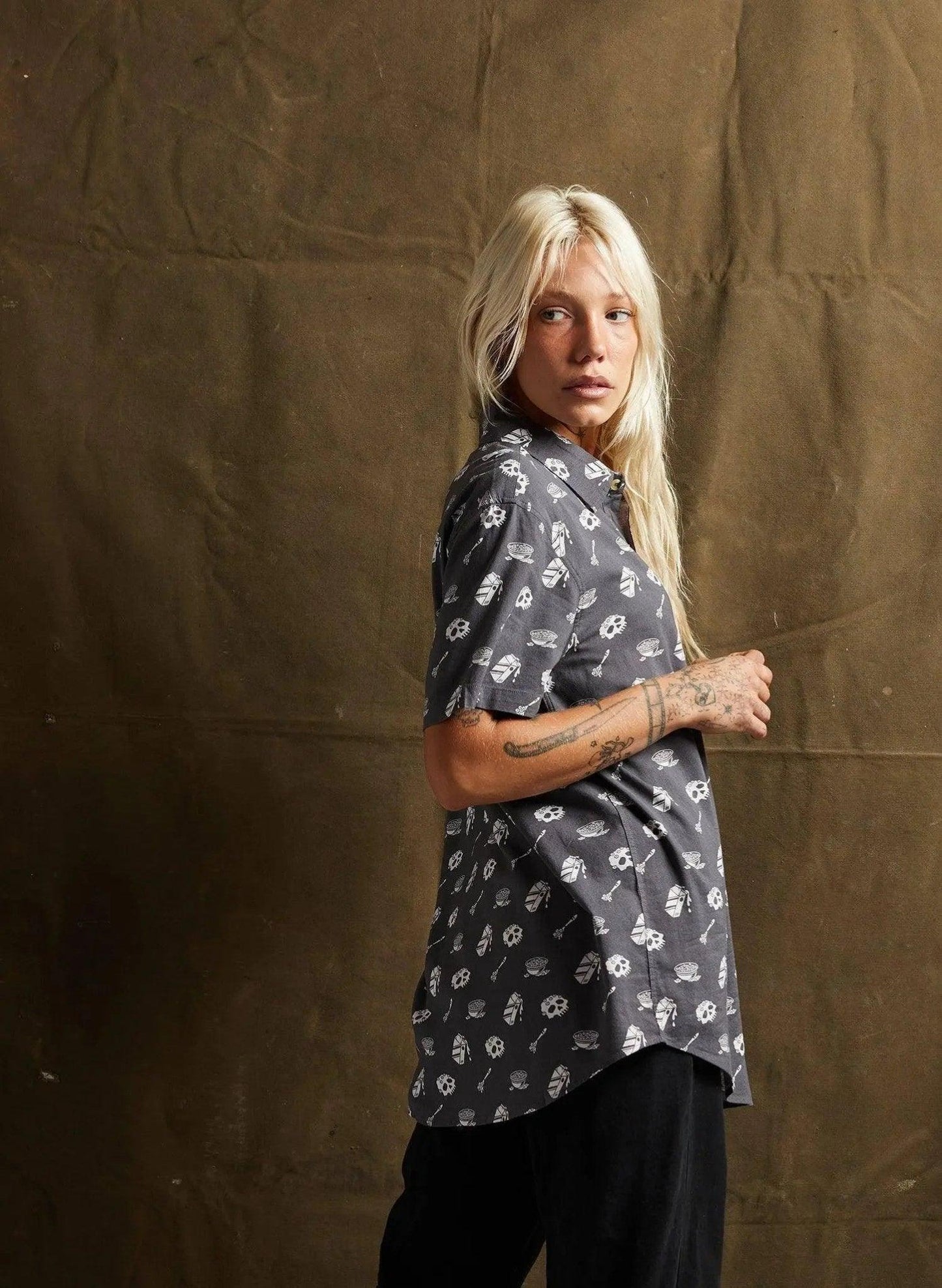 Woman in edgy skull print shirt, fashion-forward style for women's streetwear