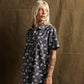 Woman wearing edgy skull print short sleeve shirt, fashion forward streetwear style