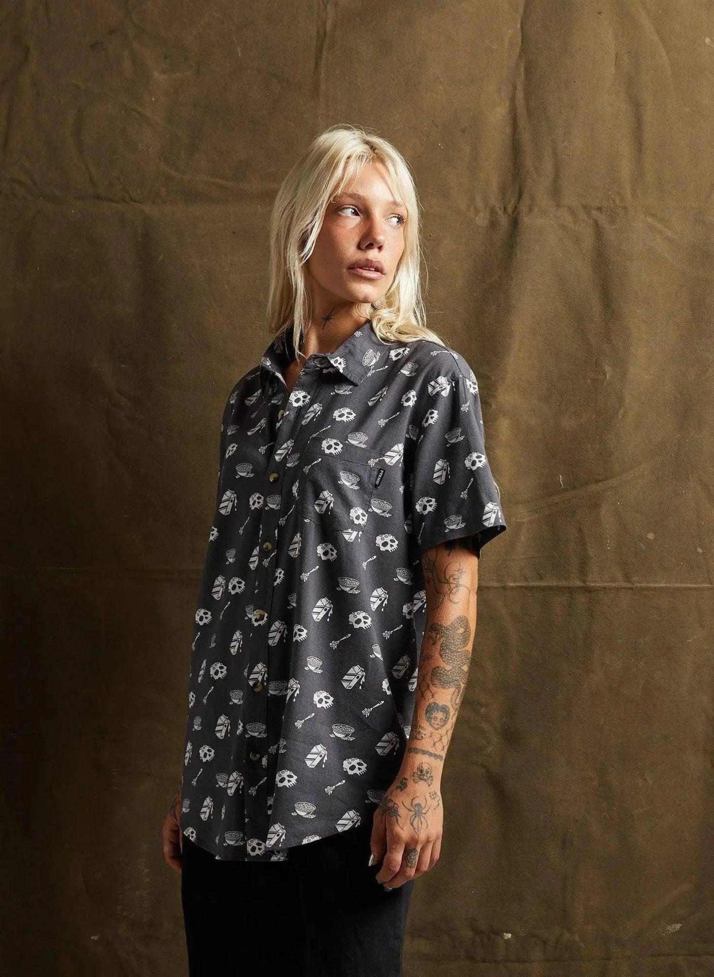Woman wearing edgy skull print short sleeve shirt, fashion forward streetwear style