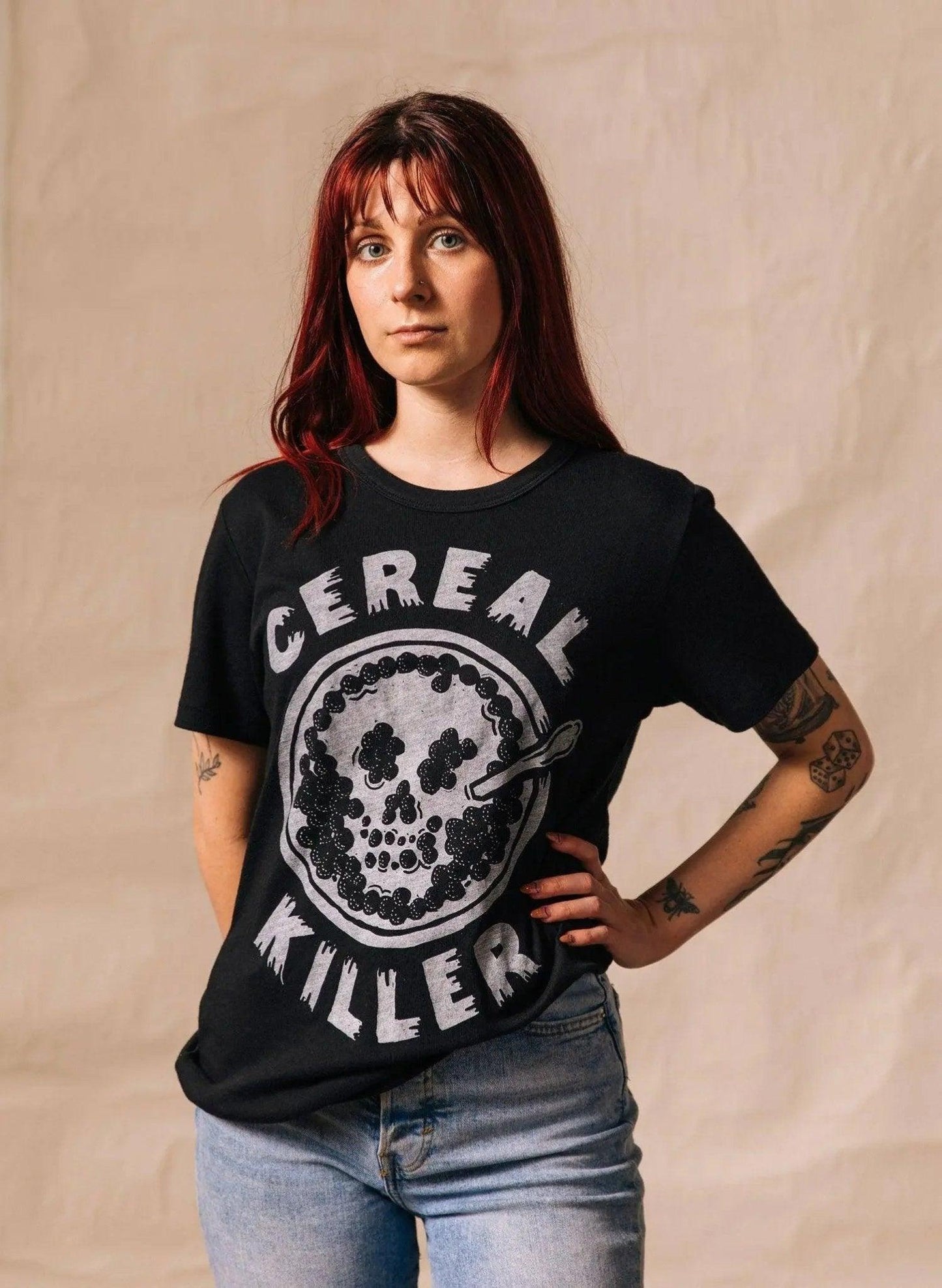 Woman wearing black 'Cereal Killer' graphic tee with skull design, casual fashion style