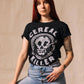 Woman wearing black 'Cereal Killer' graphic tee with skull design, paired with high-waisted jeans, edgy fashion style