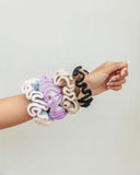 Crochet hair scrunchies in pastel and neutral colors, stylish women's fashion accessories