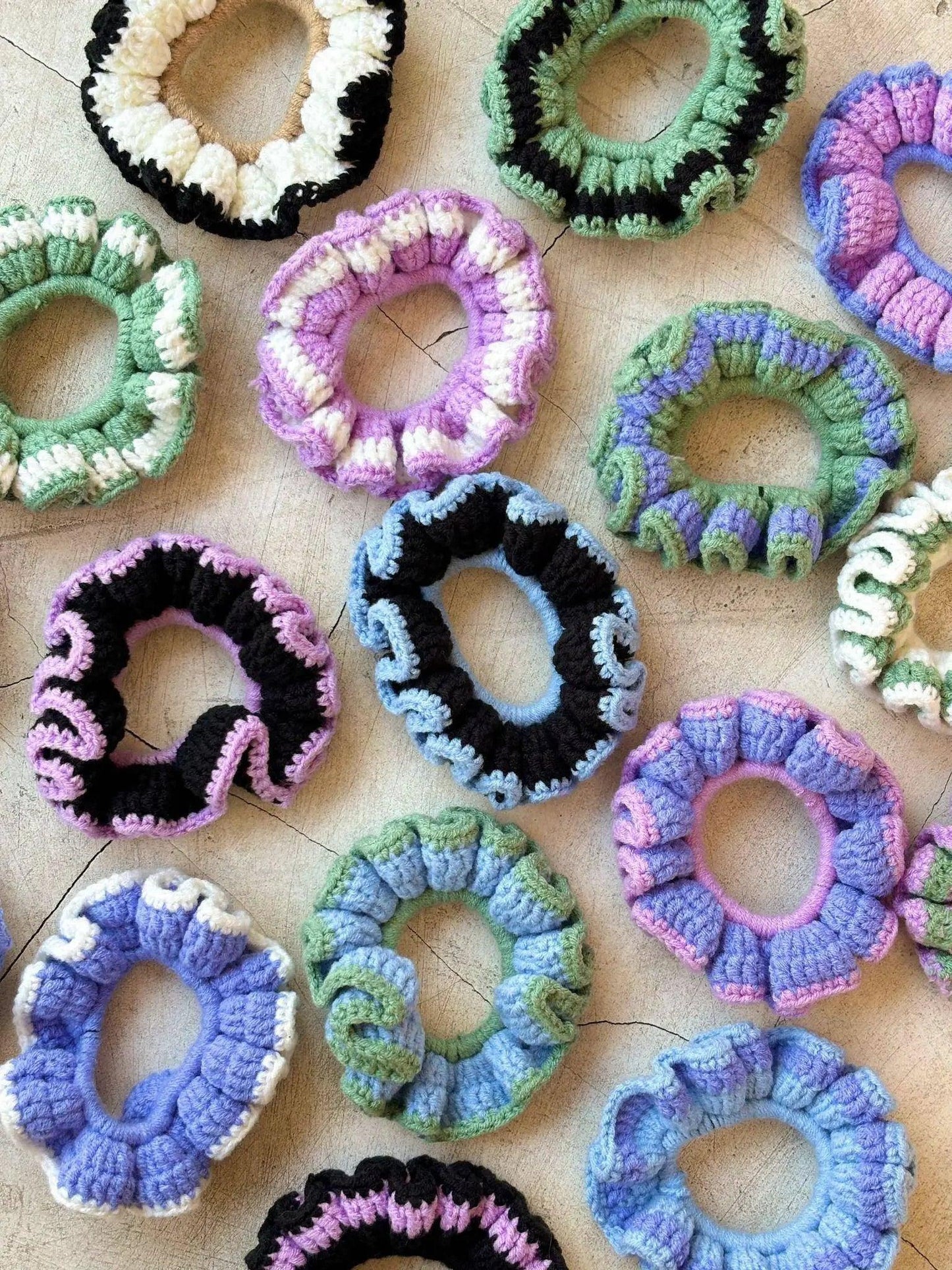 Colorful crocheted hair scrunchies in pastel and bold patterns, perfect for women's fashion accessories