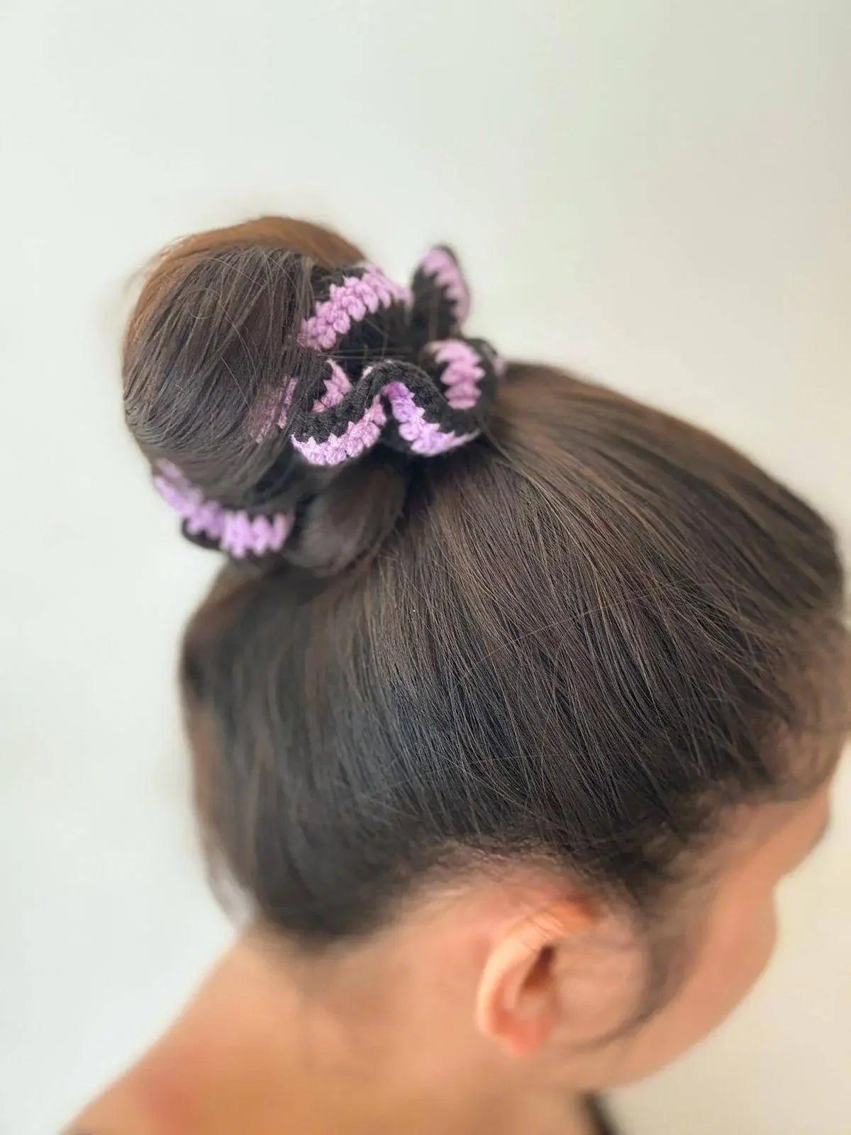 Purple and black knitted scrunchie in a sleek bun, stylish women's hair accessory for fashion looks