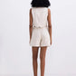 Woman in beige sleeveless top and matching shorts, back view, stylish summer fashion set