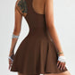 Brown racerback tennis dress with flared skirt, gold jewelry, and white fingerless gloves for women's fashion.