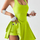 Woman in neon green athletic dress holding baseball, sporty fashion outfit