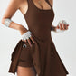 Brown athletic tank top and skort set with pockets, worn with white gloves and holding a baseball