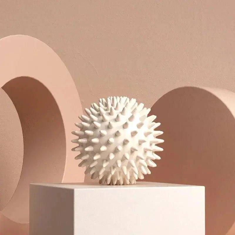 White spiky massage ball on pedestal, minimalist beauty and wellness decor