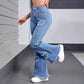 Women's distressed flare jeans with heart-shaped rips, paired with white sneakers for casual fashion
