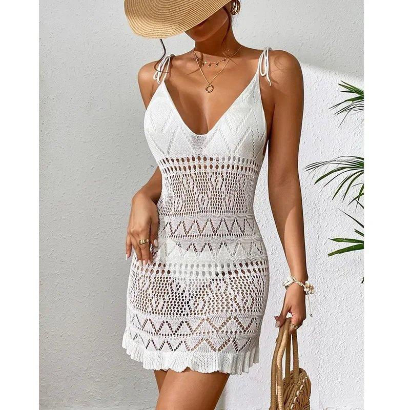 White crochet beach dress with V-neck, straw hat, and woven bag for summer fashion