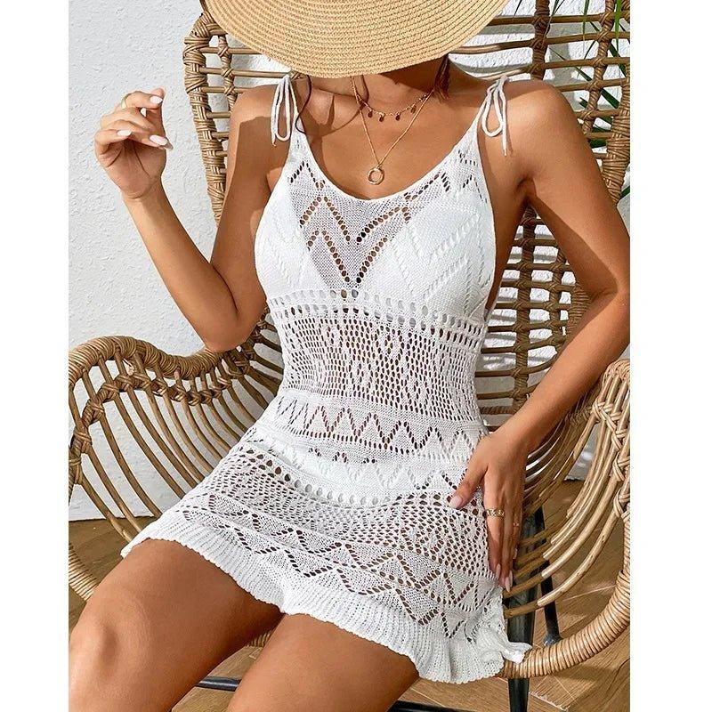 White crochet beach dress with lace detailing, straw hat, wicker chair – women’s summer fashion