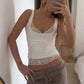 Woman in white lace-trim tank top and gray ribbed shorts, mirror selfie