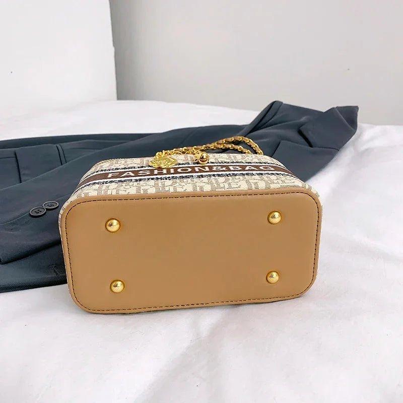 Stylish beige fashion handbag with gold chain strap and 'FASHIONBAG' print, perfect for women's outfits