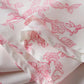 White fabric with pink floral print, soft texture and delicate stitching for women's fashion