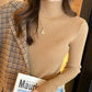 Woman in ribbed turtleneck sweater and plaid blazer, fashion outfit with gold jewelry