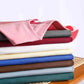 Stack of colorful women's fashion t-shirts in pink, red, white, blue, brown, gray, and green