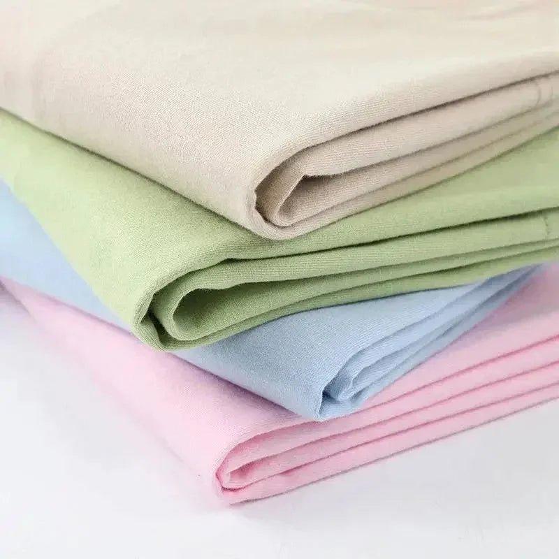 Soft pastel cotton fabric rolls in pink, blue, green, beige for women's fashion sewing projects