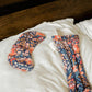 Floral print sleep mask and matching eye pillow on white bedding for women's fashion and relaxation