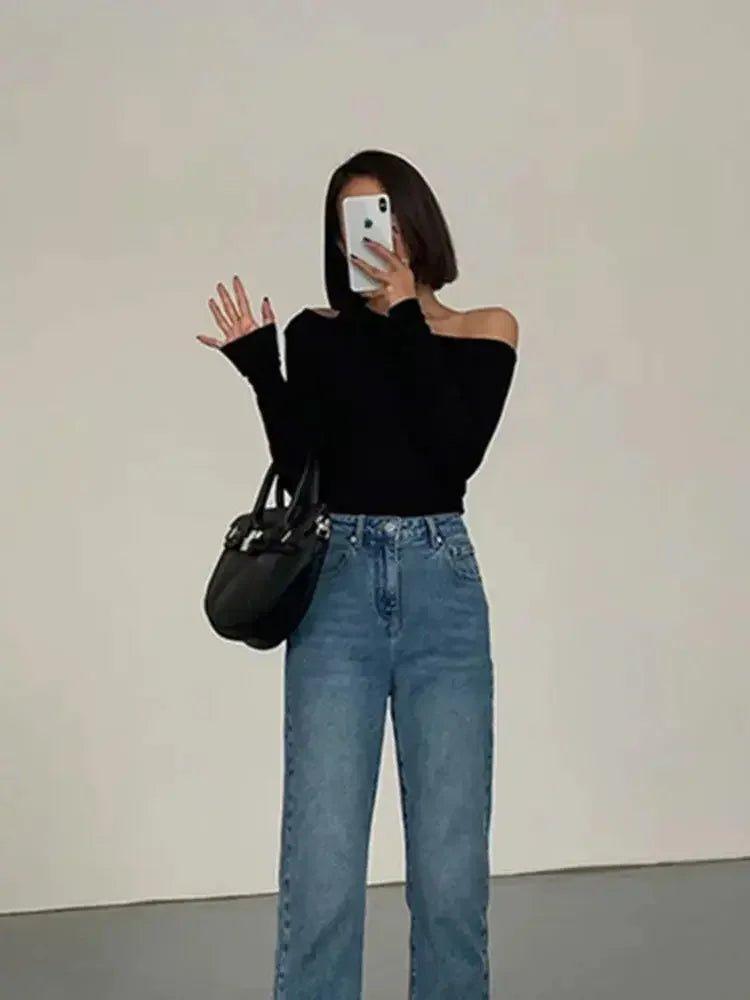 Woman in black off-shoulder top and wide-leg jeans, stylish casual fashion outfit