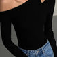 Black one-shoulder long sleeve top with cutout detail, paired with blue jeans for women's fashion