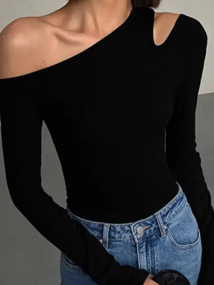 Black one-shoulder long sleeve top with cutout detail, paired with blue jeans for women's fashion