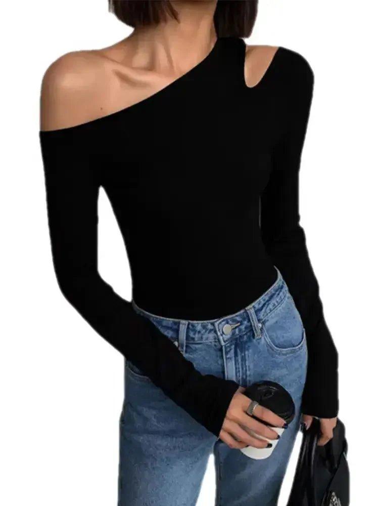 Black one-shoulder long sleeve top with cutout detail, paired with blue jeans for women's fashion