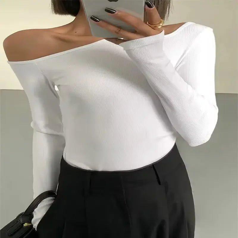 White off-shoulder long sleeve top with black high-waist pants, women's fashion outfit