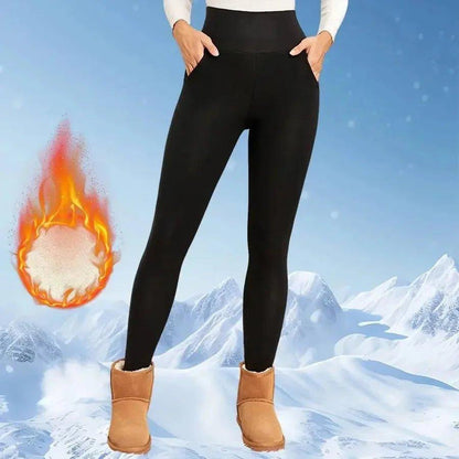 Women's black thermal leggings with pockets, cozy winter wear for snow, paired with boots