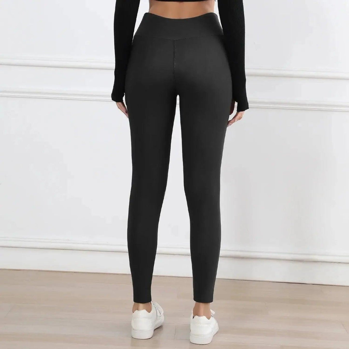 Black high-waisted leggings for women, stylish fitness wear with white sneakers, perfect for yoga or casual fashion