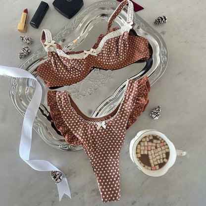 Brown polka dot lingerie set with lace trim, styled on silver tray with lipstick and hot cocoa